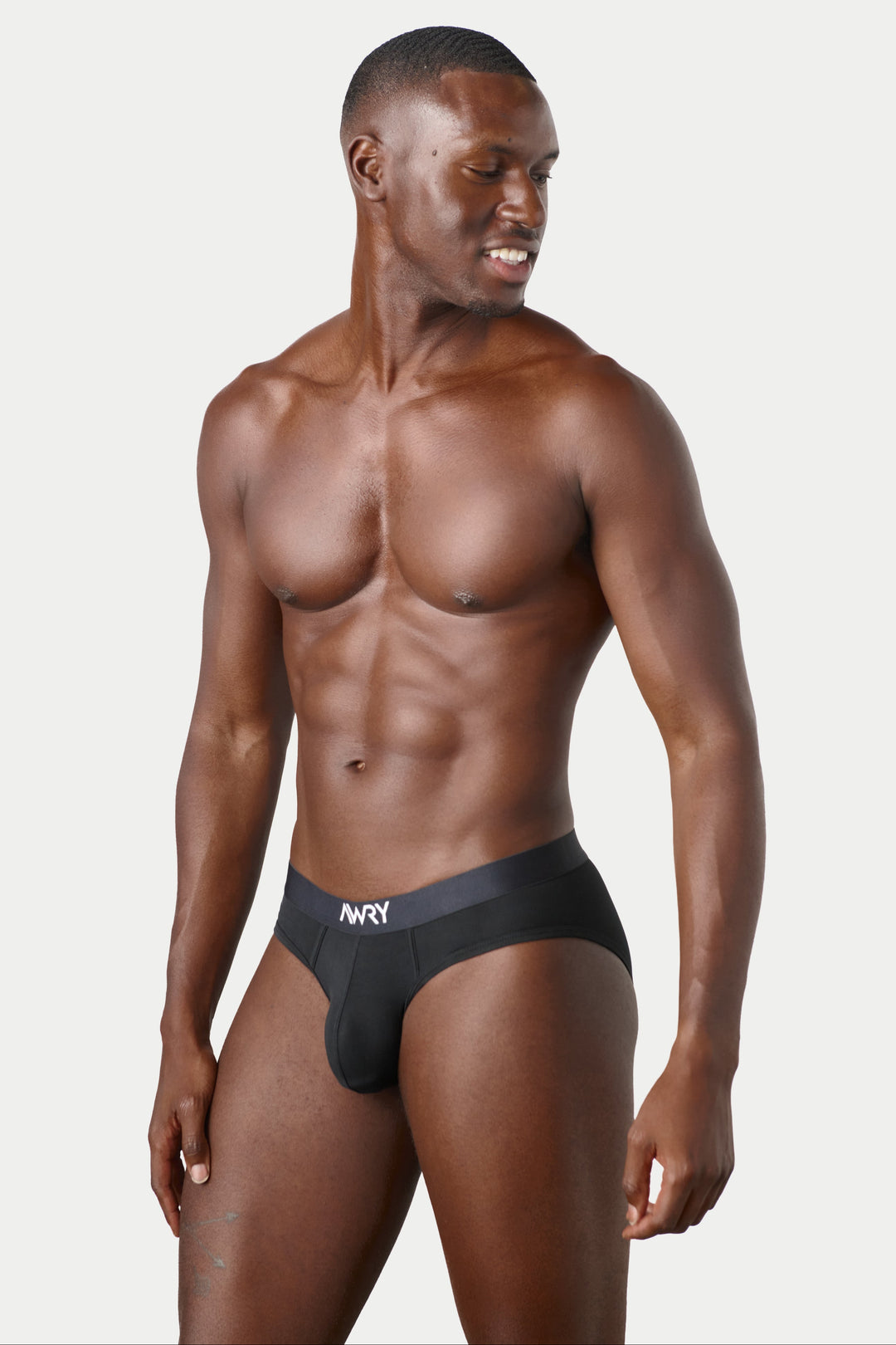 A muscular male model wearing black AWRY men&