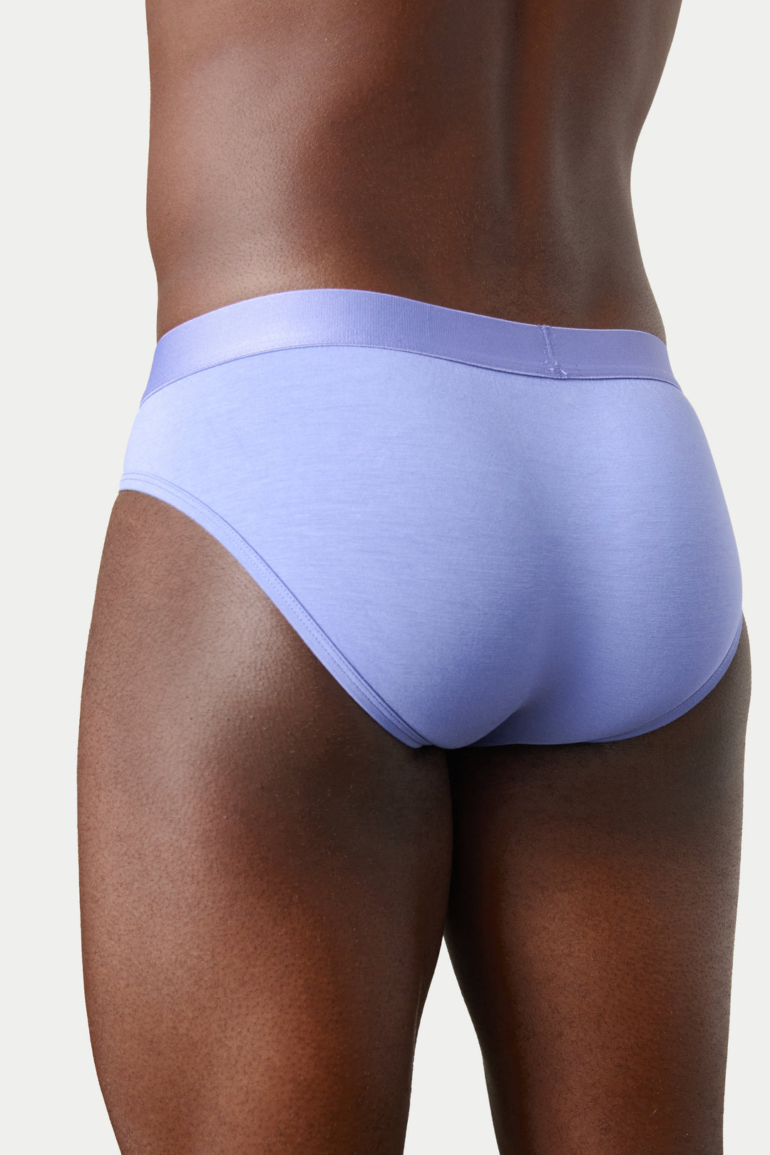 A close-up rear view of a model wearing light lavender blue men&