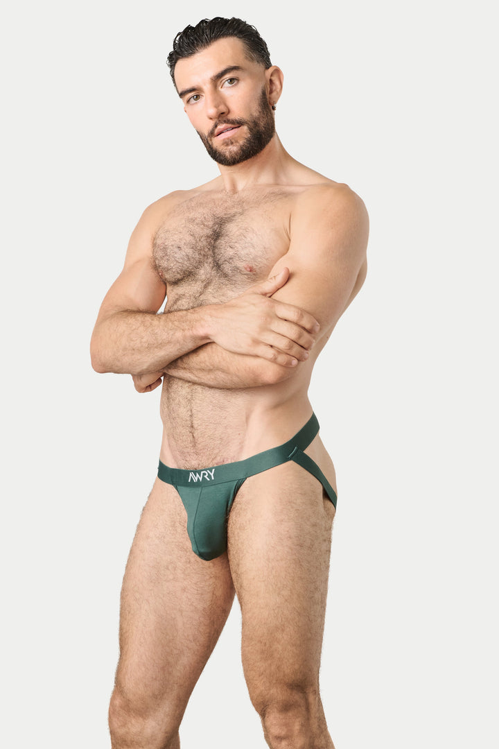 A muscular man with a beard modeling a dark green men&