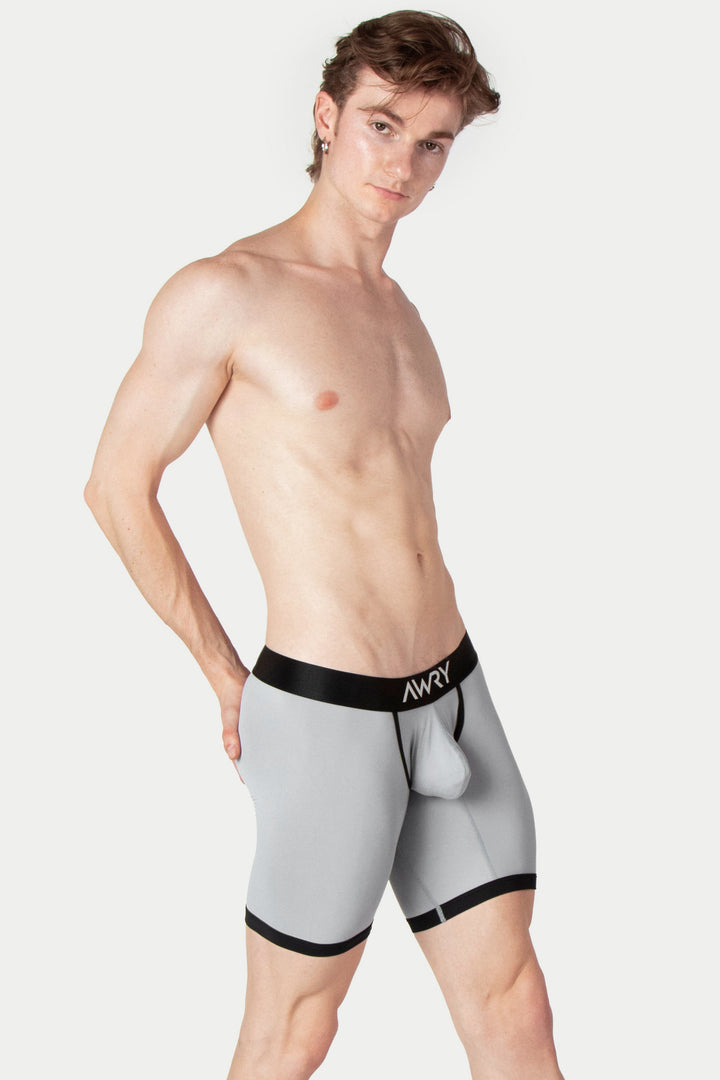 Gray boxer briefs with black waistband and leg cuffs, shown on a male model.