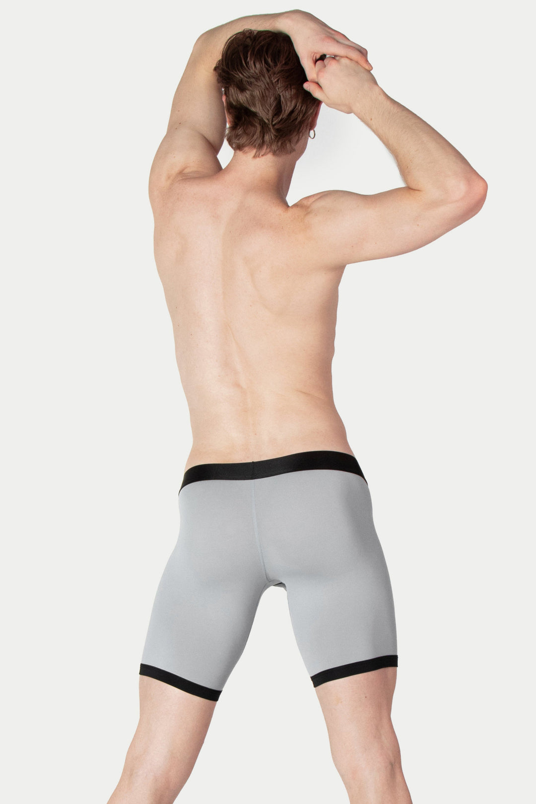 Gray boxer briefs with black waistband and leg trim, shown on model from behind.