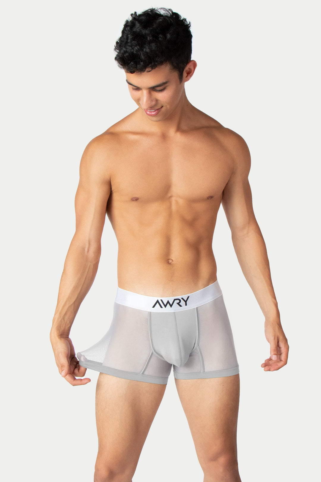 Silver thong trunks with white AWRY waistband and mesh side panels.