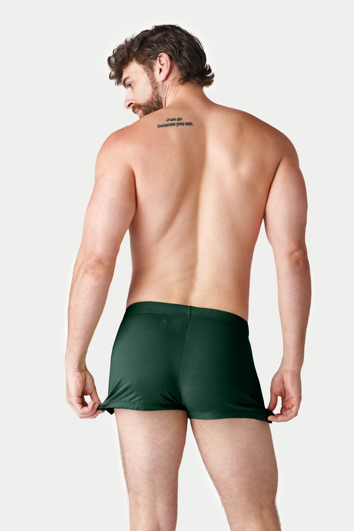 Man wearing dark green jock boxer shorts, rear view.