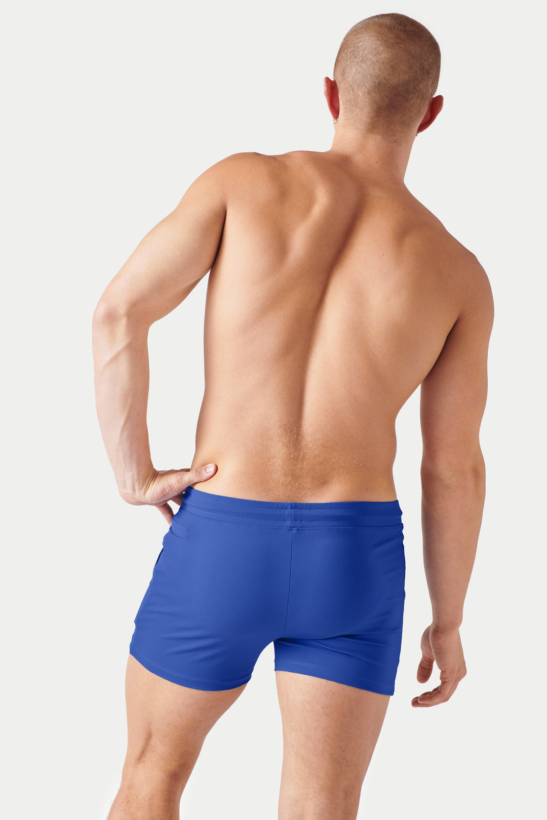 Cobalt blue shorts with elastic waistband on model shown from back view.