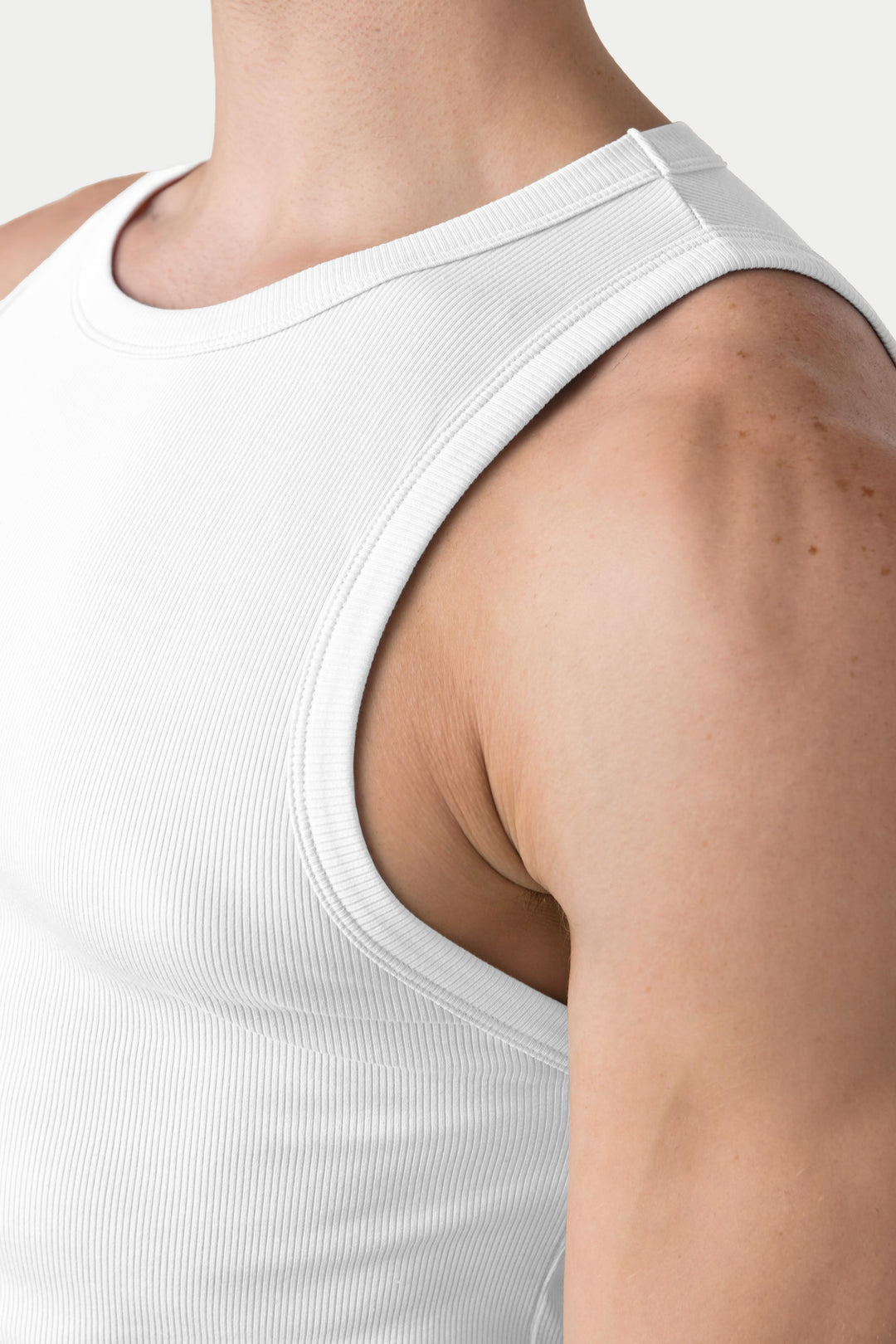 White ribbed tank top with crew neckline and sleeveless design.
