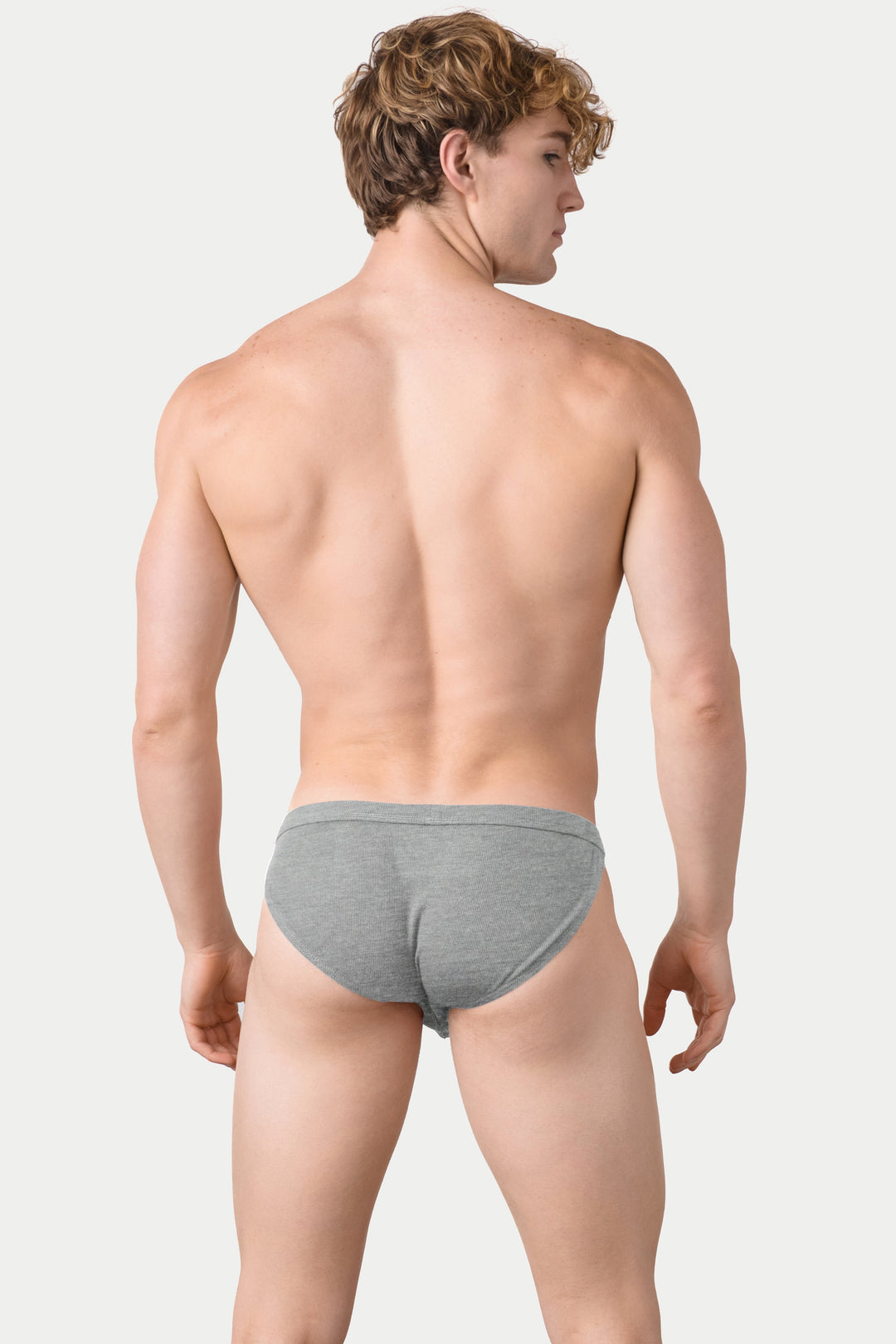 Heather gray ribbed tanga briefs on male model shown from back view.