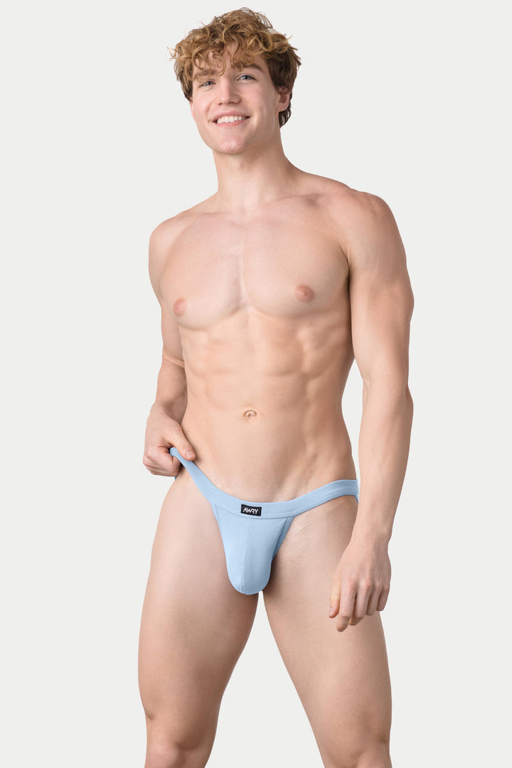 Sky blue ribbed tanga briefs with branded waistband, shown on male model.